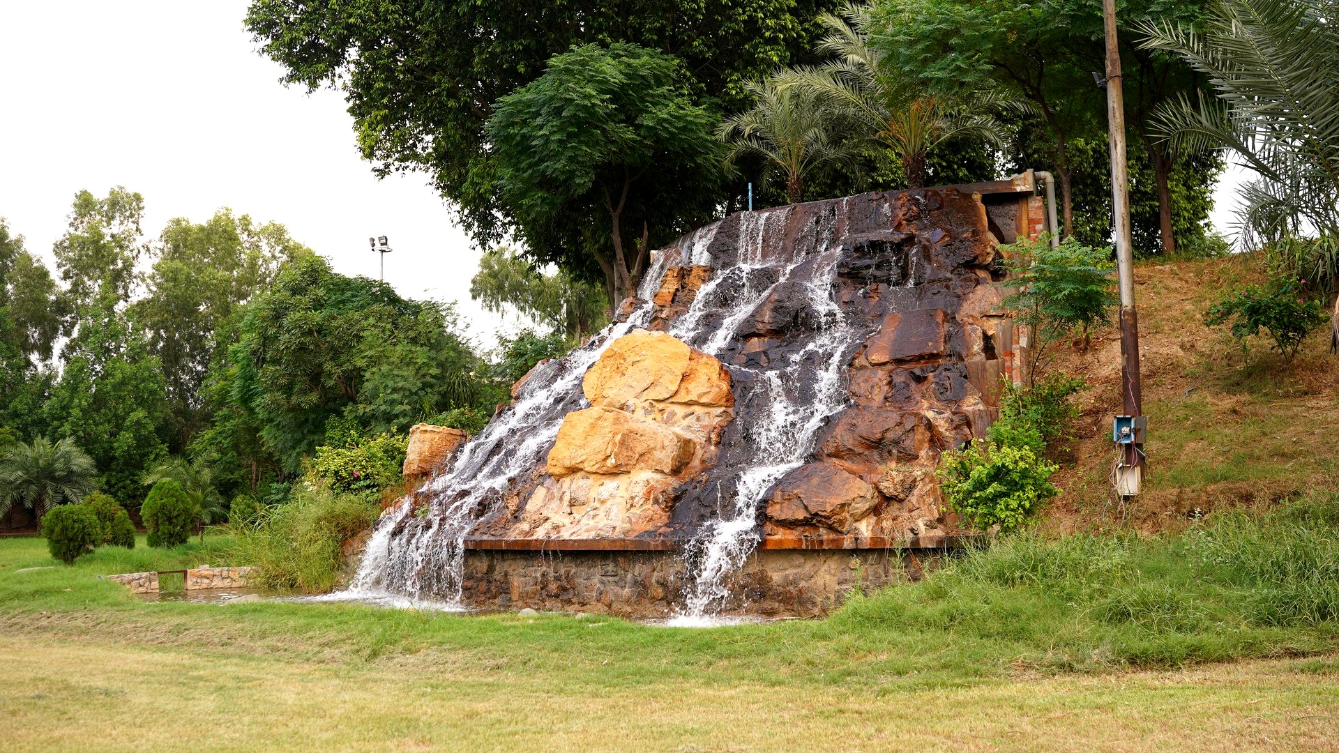 Outdoor corporate brand activation staging and illuminated waterfall festival deck at Waterfall Lawn, J5 Resort Lahore
